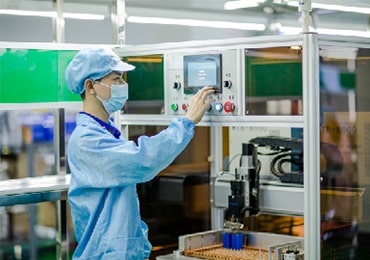 a worker is operating the lithium ion battery making machine