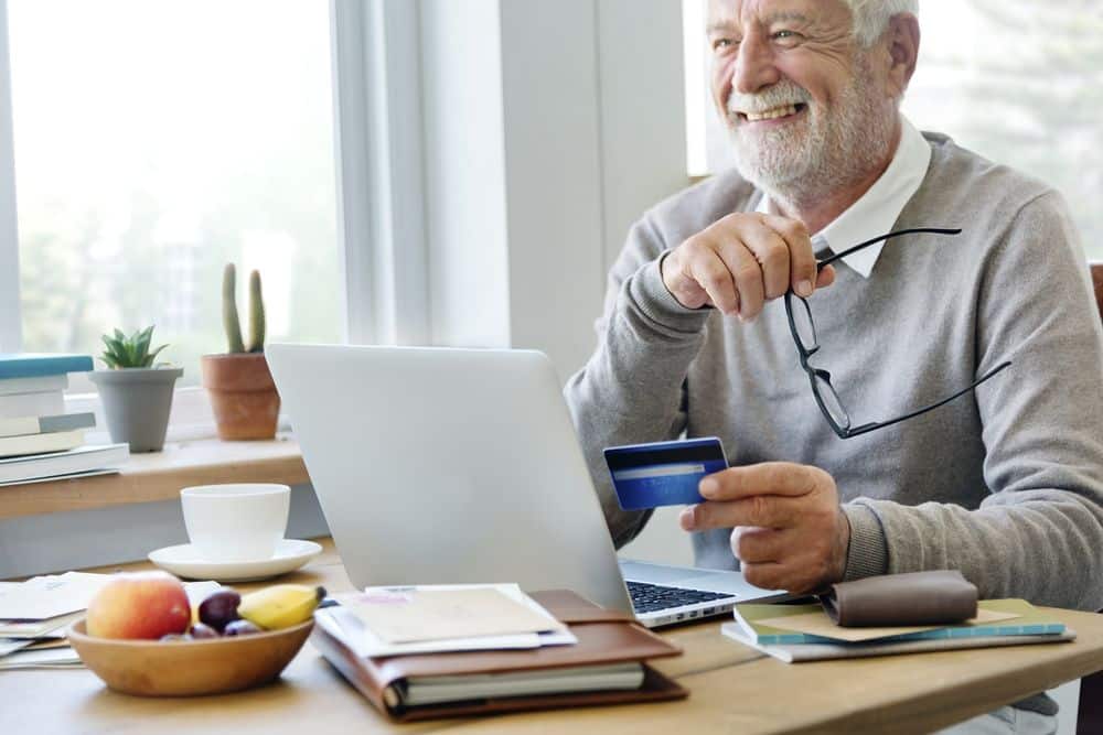 old guy with credit card in a computer